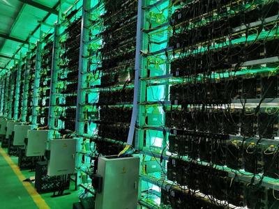 Interior of a modern mining farm with rows of mining rigs in operation