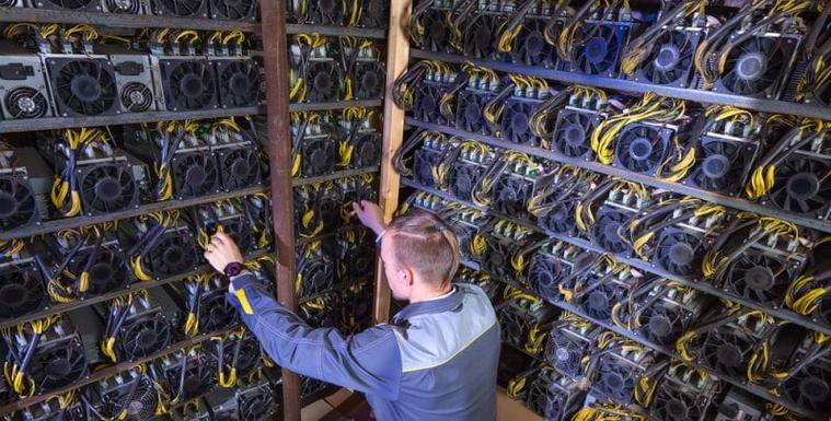 A close-up of a cryptocurrency mining rig with multiple GPUs